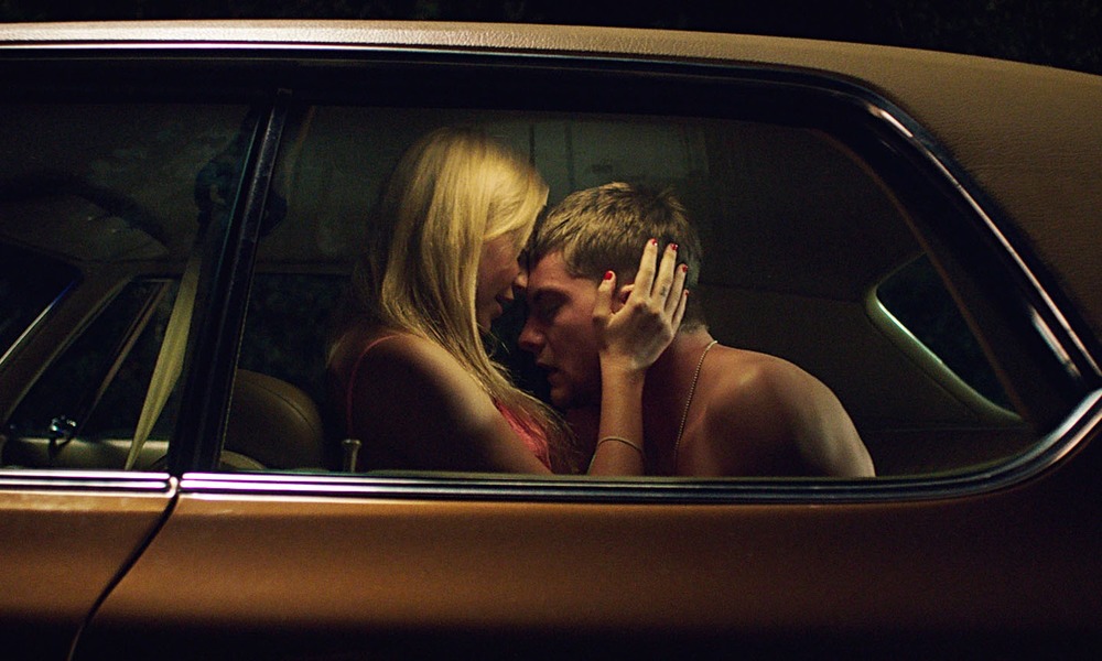 Maika Monroe and Jake Weary carry a deadly force in  It Follows.